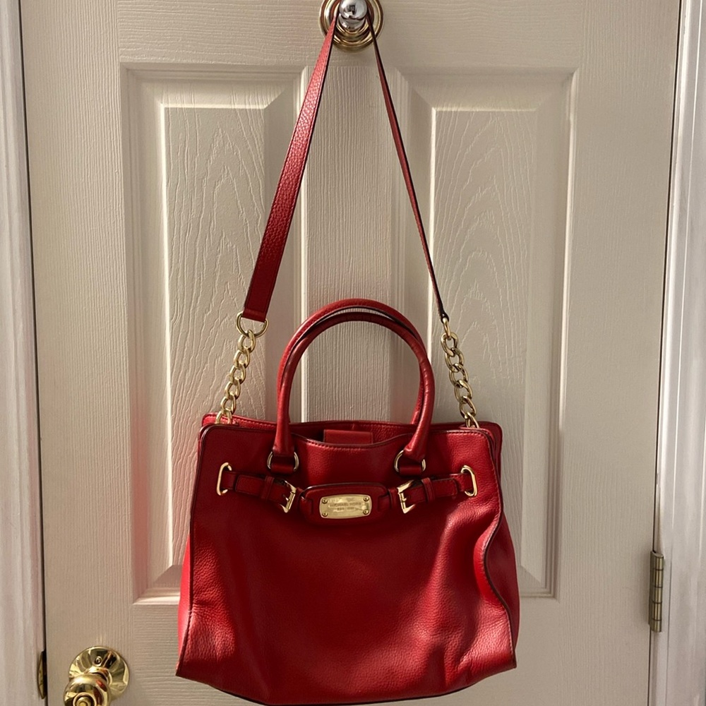 Womens red Michael Kors handbag.